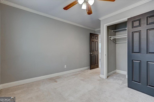 unfurnished bedroom featuring ceiling fan, a closet, light carpet, and ornamental molding