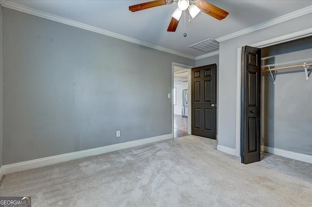 unfurnished bedroom with a closet, ceiling fan, ornamental molding, and light colored carpet