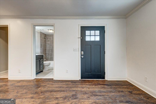 entryway with dark hardwood / wood-style flooring and crown molding