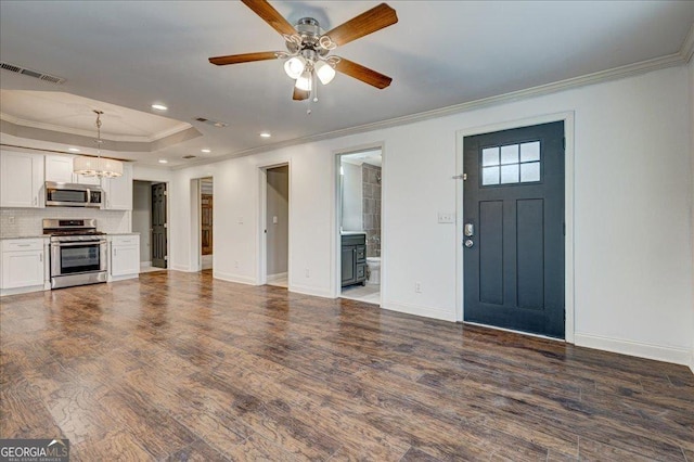 interior space with dark hardwood / wood-style floors, crown molding, and ceiling fan with notable chandelier