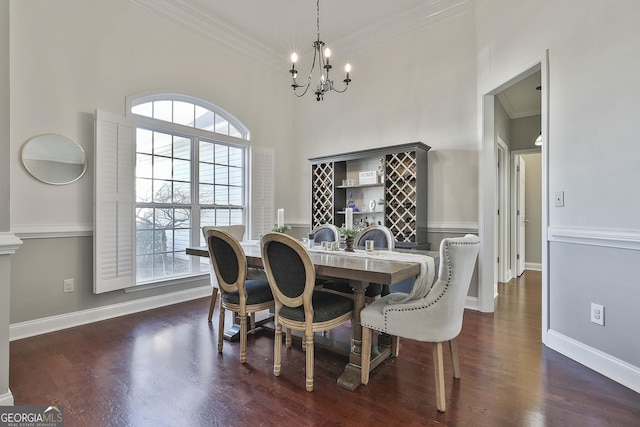 dining space with crown molding, a healthy amount of sunlight, and a notable chandelier