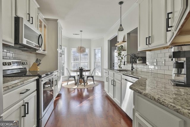 kitchen featuring pendant lighting, white cabinetry, sink, and appliances with stainless steel finishes