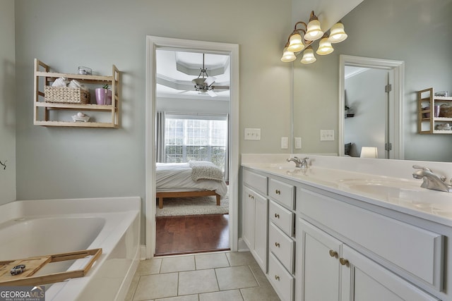 bathroom featuring ceiling fan, tile patterned floors, a bathtub, vanity, and ornamental molding