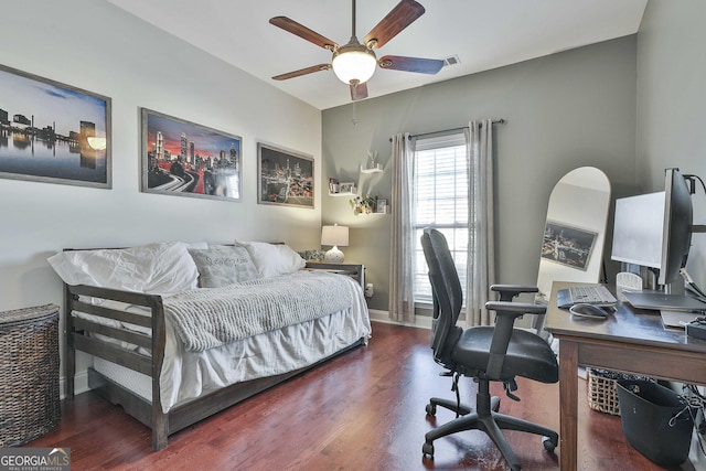 bedroom with ceiling fan and dark wood-type flooring