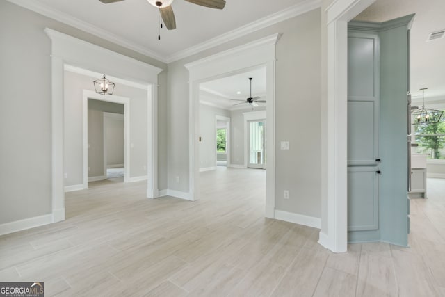 spare room with crown molding, ceiling fan with notable chandelier, and light wood-type flooring