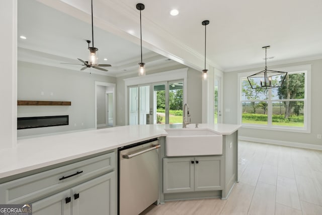 kitchen featuring dishwasher, sink, pendant lighting, and ornamental molding