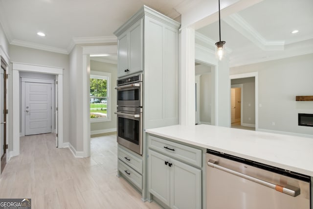 kitchen featuring ornamental molding, stainless steel appliances, and decorative light fixtures