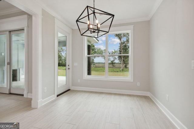 unfurnished dining area featuring light hardwood / wood-style flooring, ornamental molding, and a healthy amount of sunlight