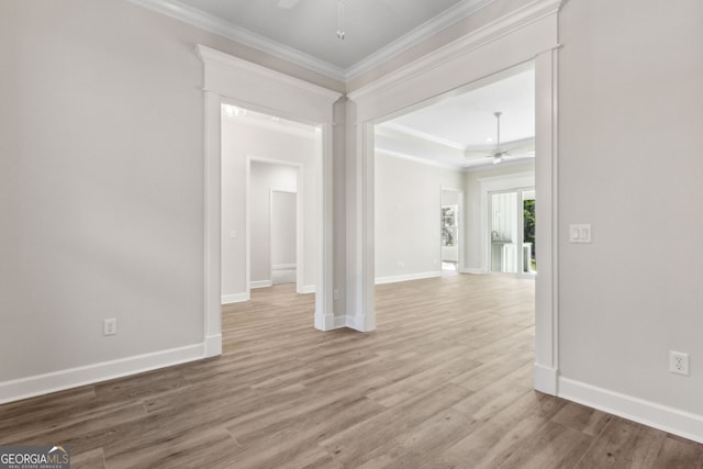 unfurnished room featuring ceiling fan, baseboards, wood finished floors, and ornamental molding