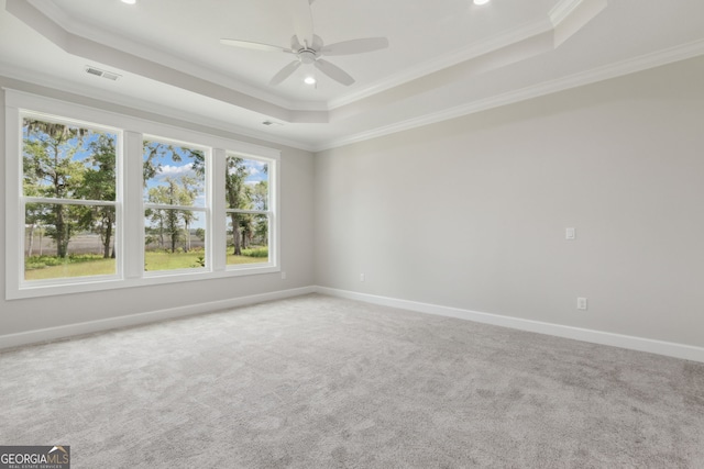 unfurnished room featuring crown molding, carpet flooring, a tray ceiling, and ceiling fan