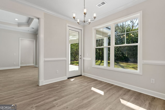 unfurnished dining area featuring visible vents, light wood-type flooring, baseboards, and ornamental molding