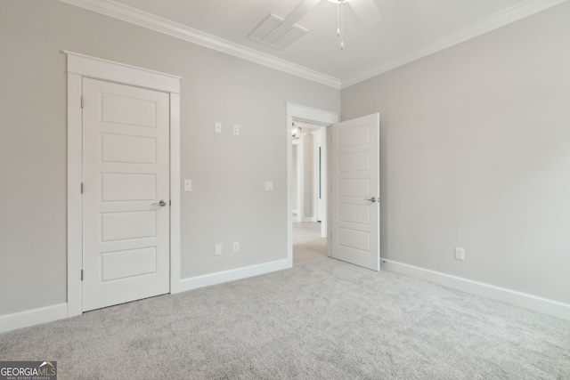 unfurnished bedroom featuring crown molding, light carpet, and ceiling fan