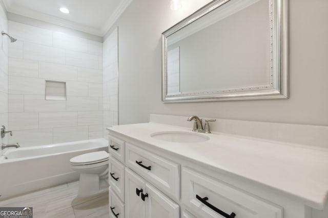 full bathroom featuring ornamental molding, toilet, tiled shower / bath combo, and vanity