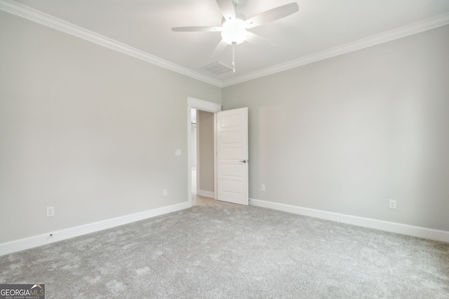 carpeted spare room featuring ornamental molding and ceiling fan