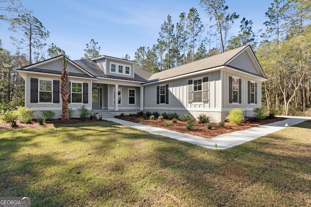 view of front facade with a front lawn, a porch, and board and batten siding