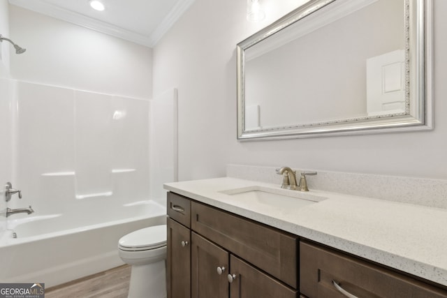 bathroom featuring vanity, wood finished floors, ornamental molding, shower / tub combination, and toilet