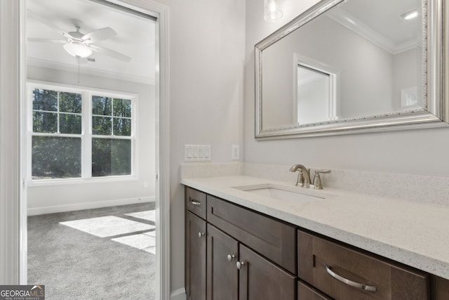 bathroom with vanity, ceiling fan, baseboards, and ornamental molding