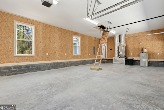 garage with a garage door opener and electric water heater