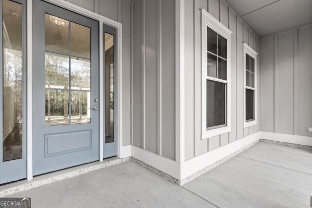 entrance foyer with crown molding, an inviting chandelier, and light wood-type flooring