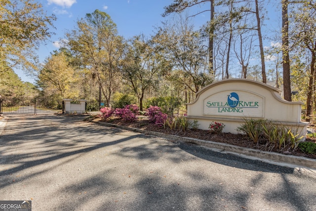 community sign featuring a gate