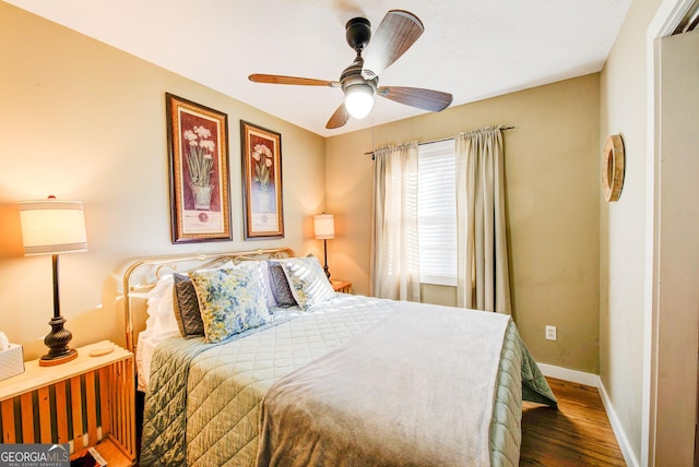 bedroom with ceiling fan and dark hardwood / wood-style floors