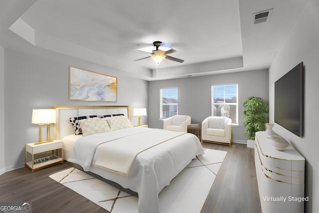 bedroom featuring a raised ceiling, ceiling fan, and wood-type flooring