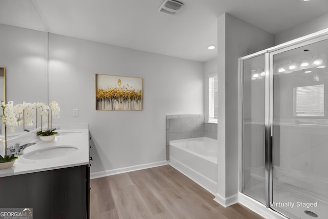 bathroom with vanity, separate shower and tub, and wood-type flooring