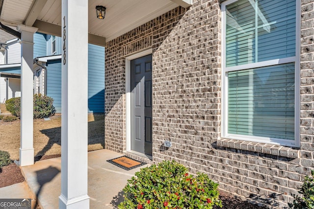 view of exterior entry with a porch