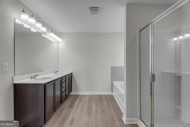 bathroom featuring separate shower and tub, vanity, and wood-type flooring