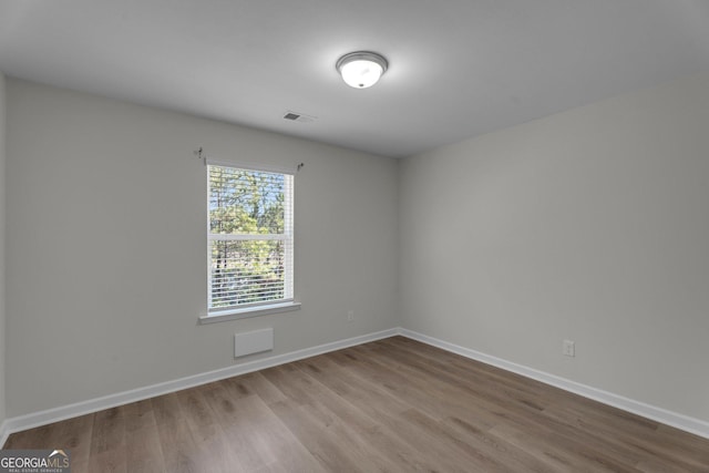 empty room with wood-type flooring