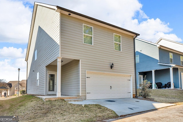 view of front of house with a garage and a front lawn