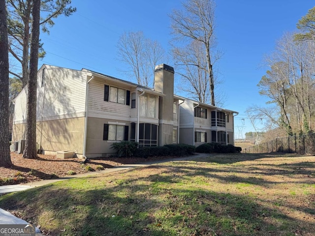 back of property featuring a lawn