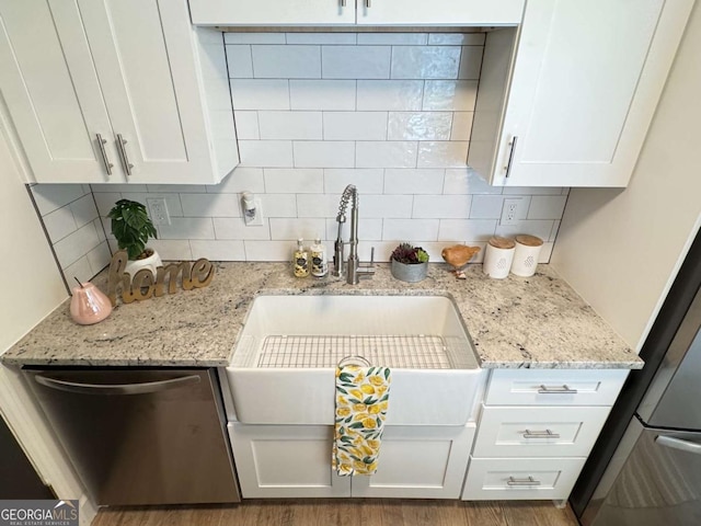 kitchen with dishwasher, tasteful backsplash, and white cabinetry