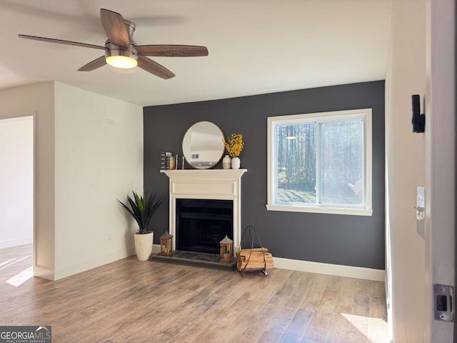 living room featuring hardwood / wood-style floors and ceiling fan