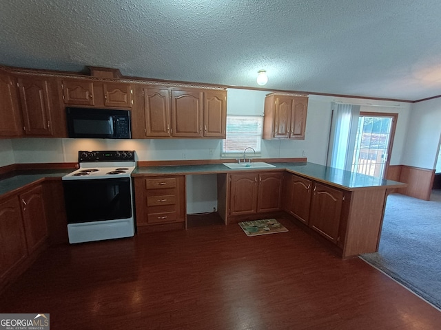 kitchen featuring a textured ceiling, white appliances, a wealth of natural light, and sink