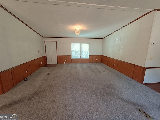 carpeted spare room with crown molding