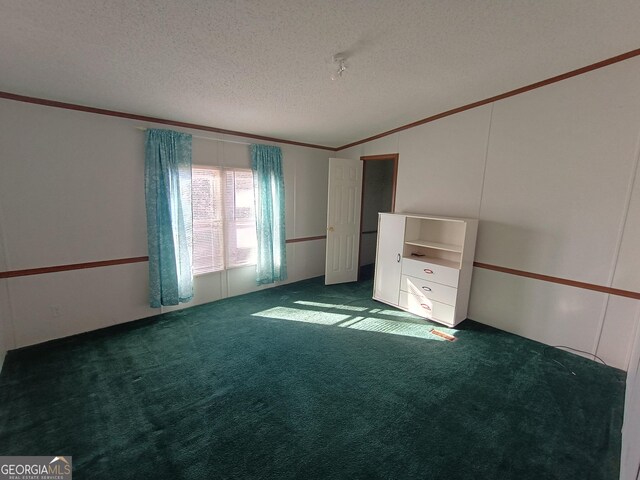 unfurnished bedroom featuring dark colored carpet and a textured ceiling