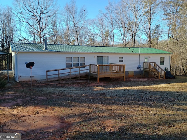 back of property featuring a deck