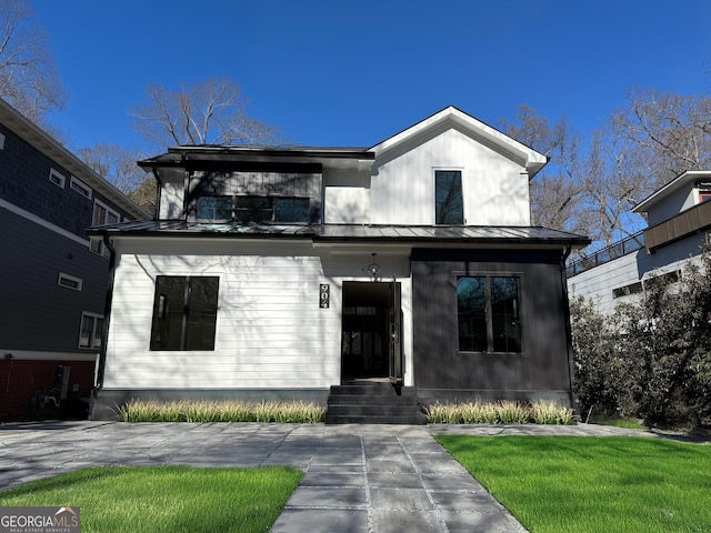 modern farmhouse style home with a front yard