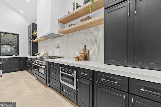 kitchen featuring appliances with stainless steel finishes, backsplash, light stone counters, custom exhaust hood, and vaulted ceiling