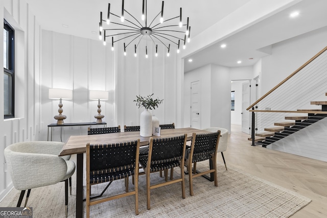 dining space featuring light parquet floors and a chandelier