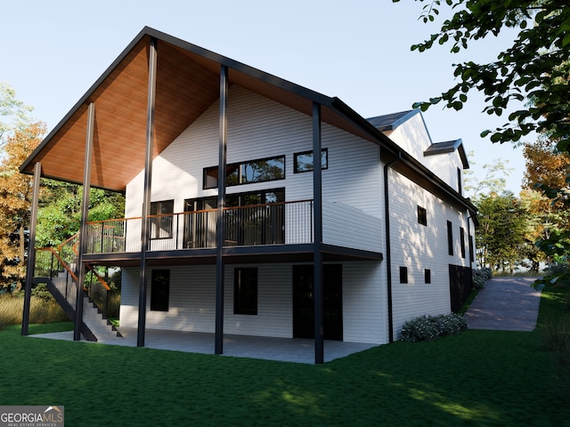 rear view of house with a lawn, a patio area, and a deck