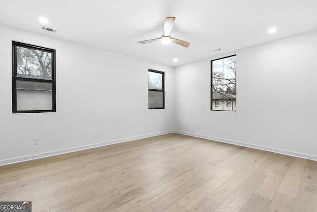 unfurnished room with ceiling fan and light hardwood / wood-style flooring