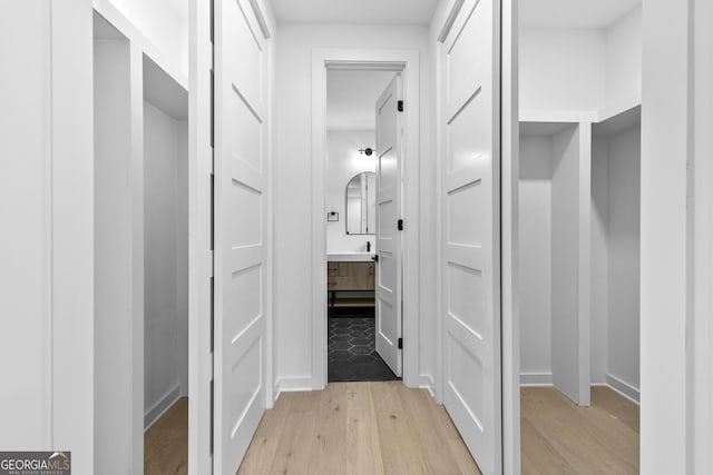 corridor with light wood-type flooring