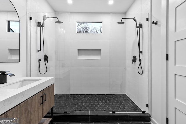 bathroom featuring vanity and tiled shower