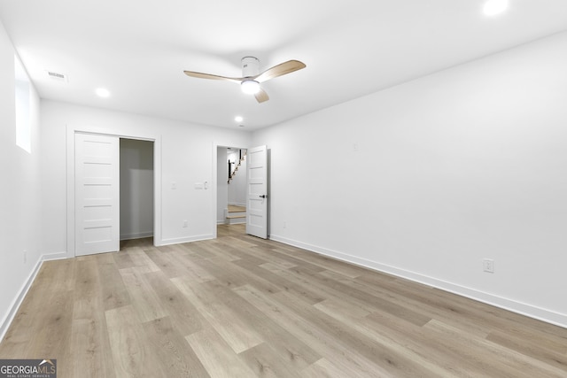 unfurnished bedroom featuring ceiling fan, a closet, and light wood-type flooring