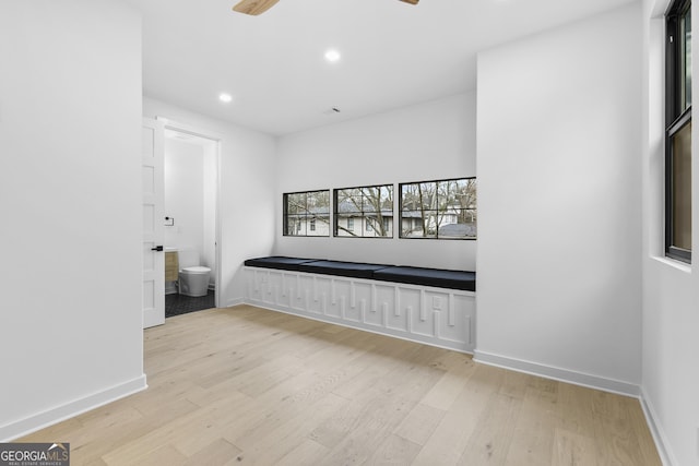 hallway with light hardwood / wood-style floors