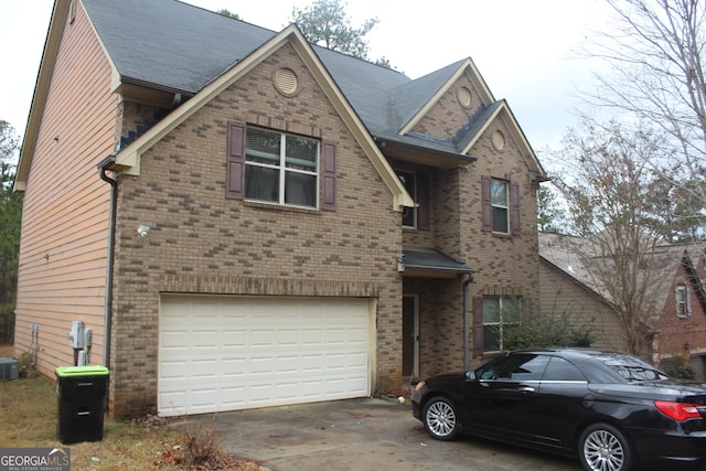 view of front of property with a garage and cooling unit