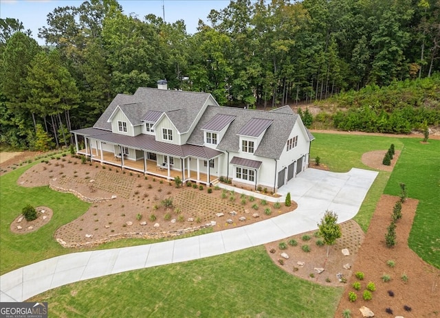 view of front of home with a porch, a garage, and a front lawn