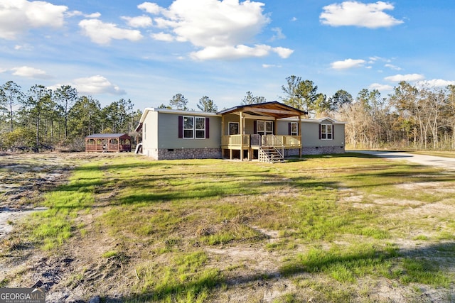 back of property with a lawn